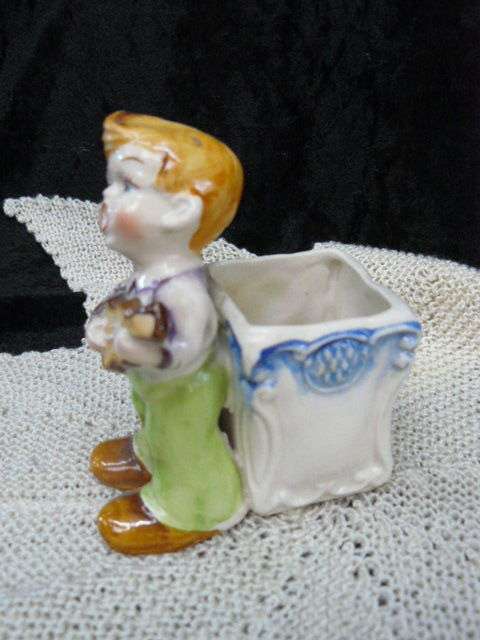 CERAMIC BOY FIGURINE WITH BASKET