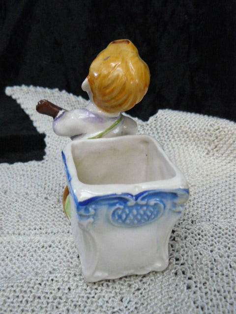 CERAMIC BOY FIGURINE WITH BASKET
