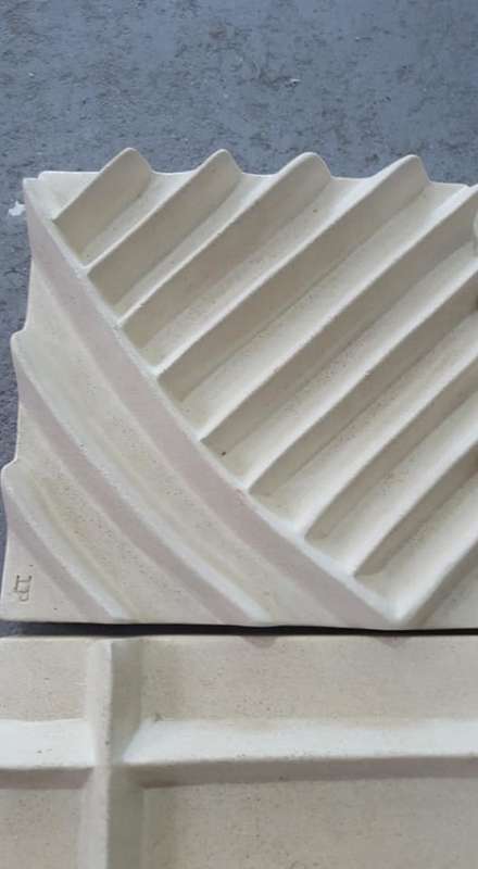 Unique plastered finish/cement type material. Wall hanging--great appeal,funky,modern!!