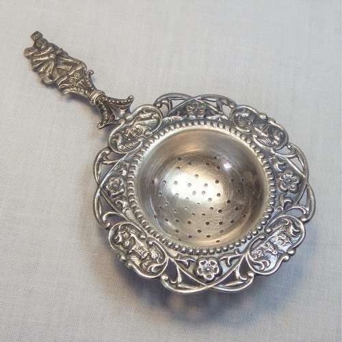 EPNS tea strainer with floral decor
