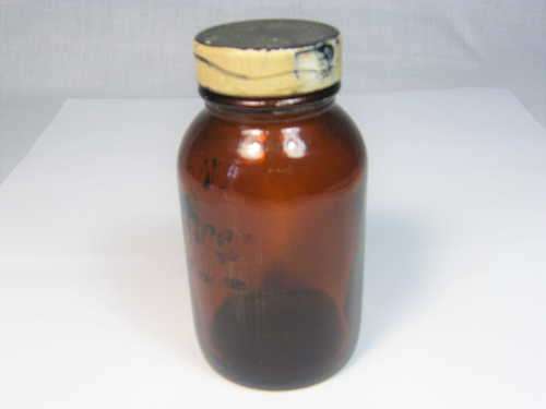 Unknown vintage glass bottle with lid - Marked with a circled `R`