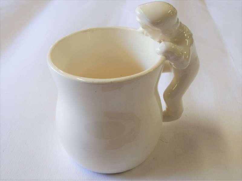 Vintage Character mug of man climbing in to save woman