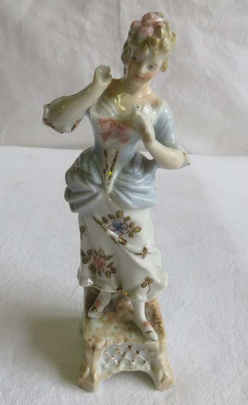 Continental C 1900 woman holding dove figurine - One finger damaged