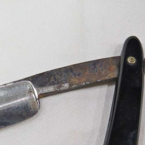 Vintage cut throat razor with chipped blade in box