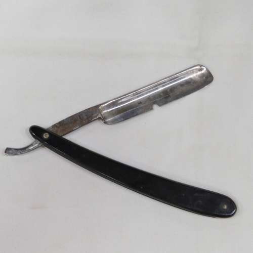 Vintage cut throat razor with chipped blade in box