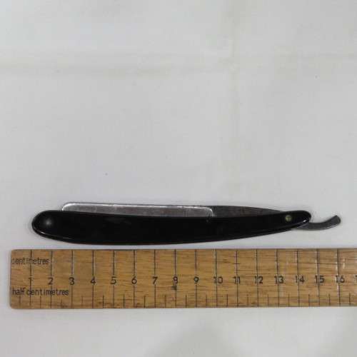 Vintage cut throat razor with chipped blade in box