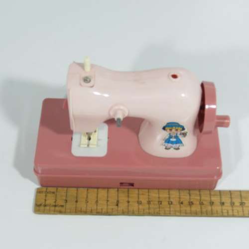 Vintage manual operated toy sewing machine