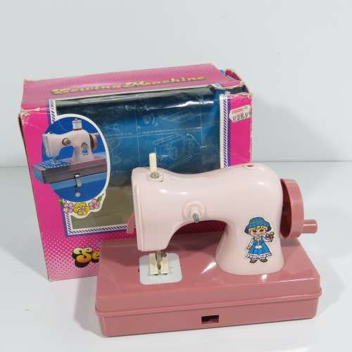 Vintage manual operated toy sewing machine