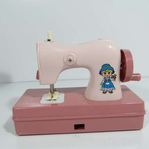 Vintage manual operated toy sewing machine