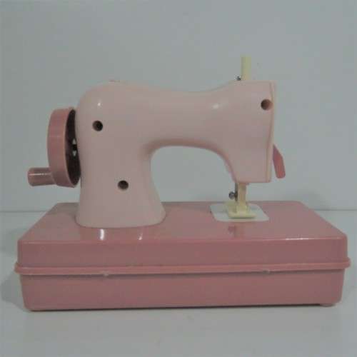 Vintage manual operated toy sewing machine