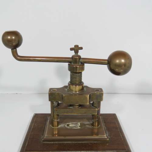 Antique brass nutcracker press on wooden piece