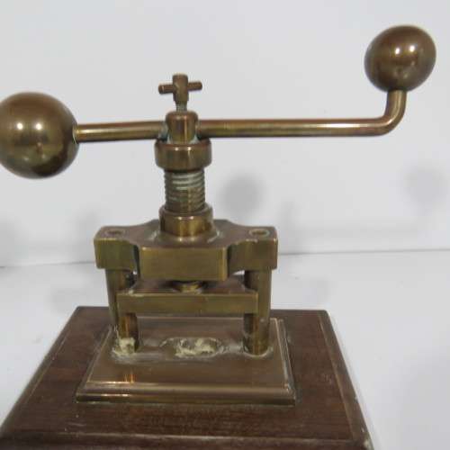 Antique brass nutcracker press on wooden piece