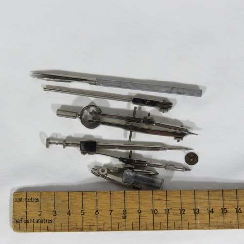 Vintage tin with technical drawing instrument parts