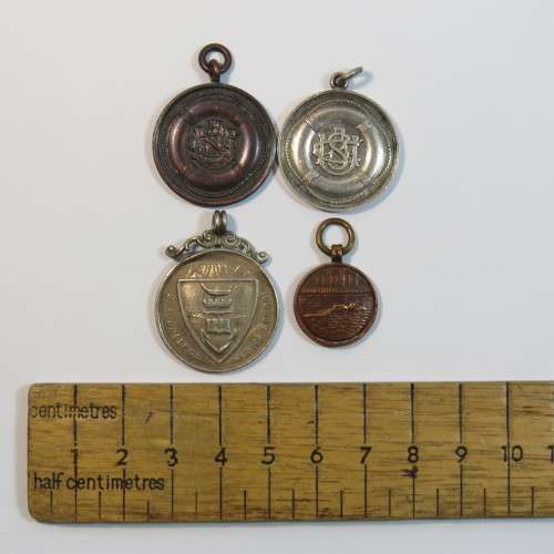 Lot of 4 swimming medals awarded to L.Abrahamson - Two in silver and 2 bronze