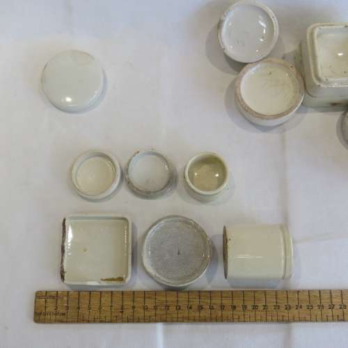 Lot of antique toothpaste and other holders and lids - 19 Pieces in total