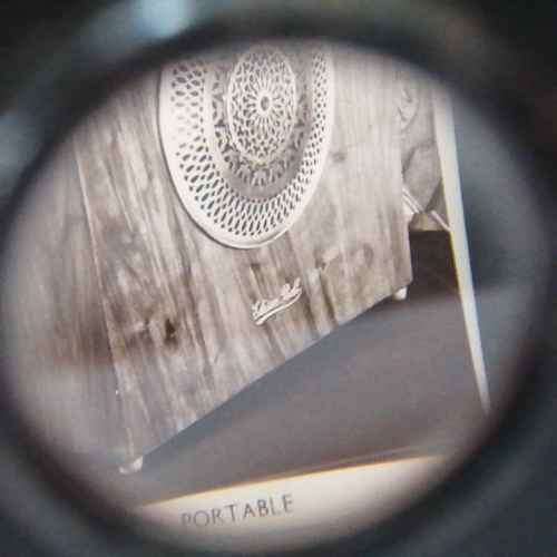 Antique metal case pocket stereo viewer with slides