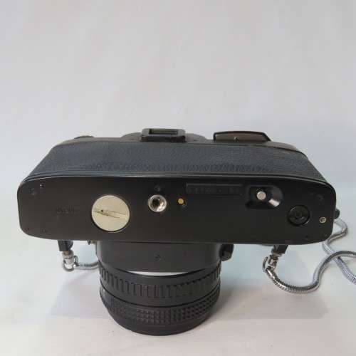 Ricoh KR-10 camera in pouch with Rikenon 1:2 50 mm lens and booklets