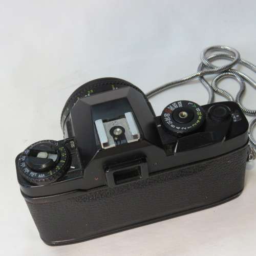Ricoh KR-10 camera in pouch with Rikenon 1:2 50 mm lens and booklets