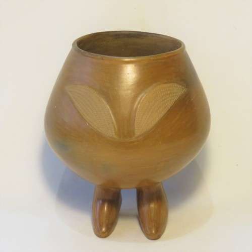 Unique clay pot standing on its own feet