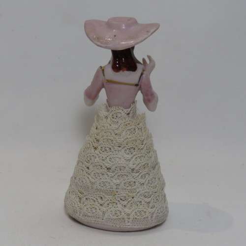 Antique small porcelain doll with material clothes