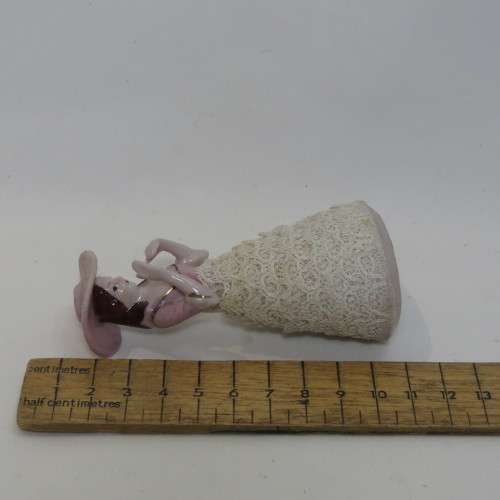 Antique small porcelain doll with material clothes