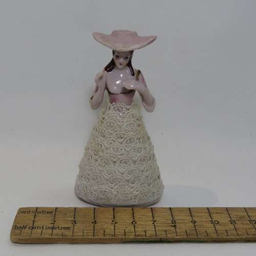 Antique small porcelain doll with material clothes