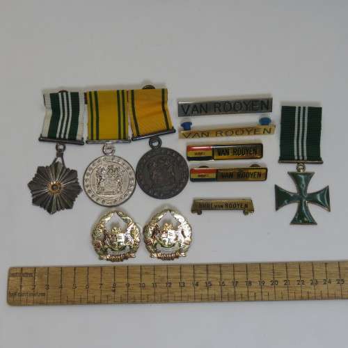 Set of SA Prison Service medals and badges issued to Warrant officer RJ. Van Rooyen