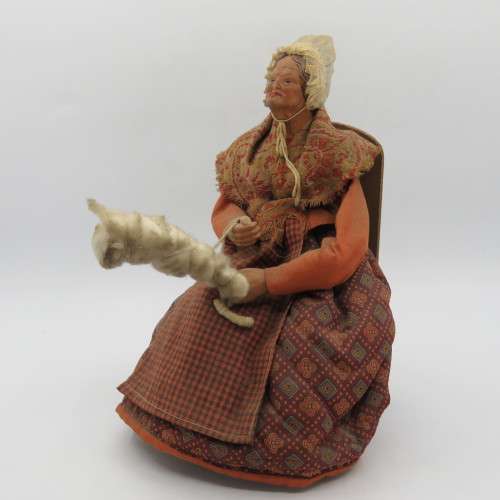 Antique French Santon clay grandma doll on chair