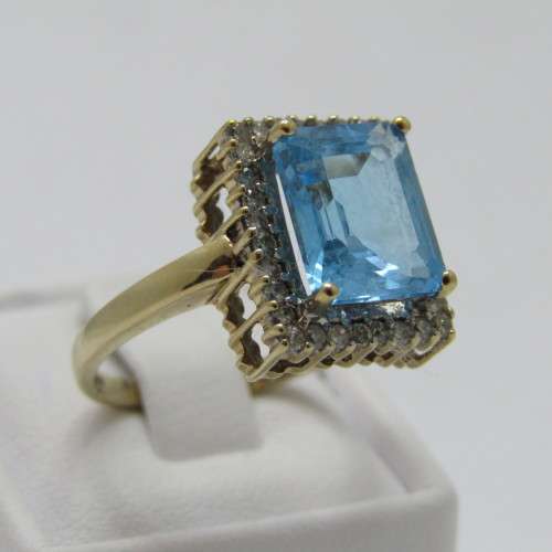 9kt Gold ring with 3.5ct blue topaz and small diamonds of 0.28ct in total - weighs 4.8g - size O/7