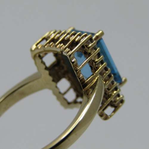 9kt Gold ring with 3.5ct blue topaz and small diamonds of 0.28ct in total - weighs 4.8g - size O/7