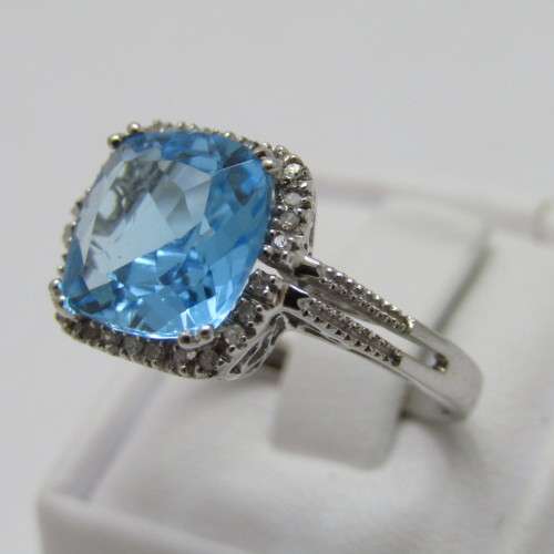 9kt Gold ring with blue Topaz and small diamonds of 0.13ct - weighs 3.5g - size N/7 - new never worn