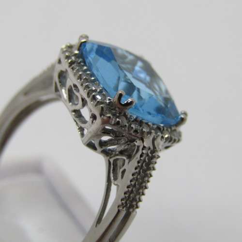 9kt Gold ring with blue Topaz and small diamonds of 0.13ct - weighs 3.5g - size N/7 - new never worn