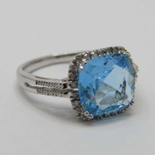 9kt Gold ring with blue Topaz and small diamonds of 0.13ct - weighs 3.5g - size N/7 - new never worn