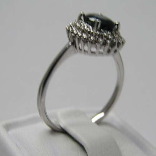 9kt Gold ring with blue sapphire and 8 small diamonds - weighs 2.6g - size M/7