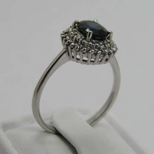 9kt Gold ring with blue sapphire and 8 small diamonds - weighs 2.6g - size M/7