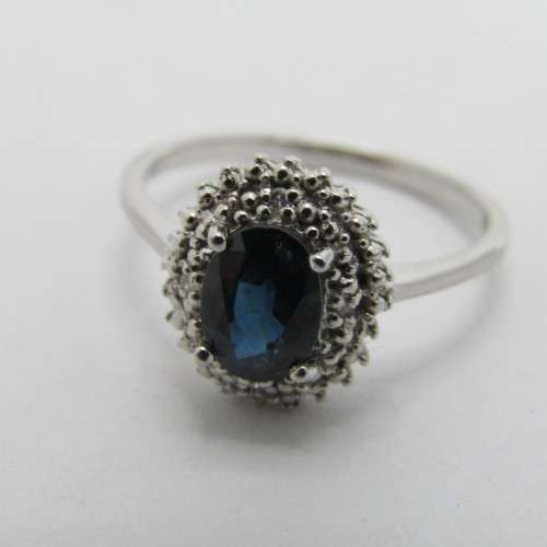 9kt Gold ring with blue sapphire and 8 small diamonds - weighs 2.6g - size M/7