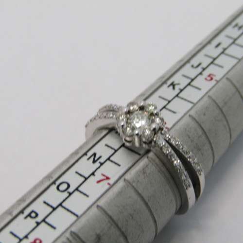 9kt White gold diamond ring with 0.11ct diamond and small diamonds of 0.25ct in total