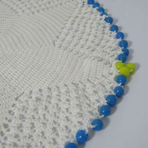 Old doily with blue and yellow beads handmade