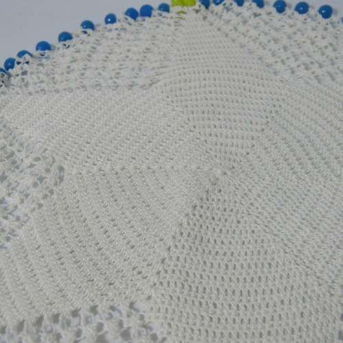 Old doily with blue and yellow beads handmade