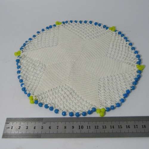 Old doily with blue and yellow beads handmade