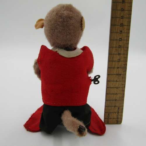 Vintage mechanical monkey toy that does back flips