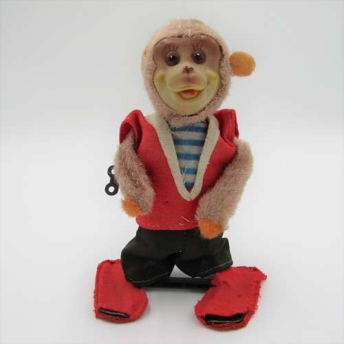 Vintage mechanical monkey toy that does back flips