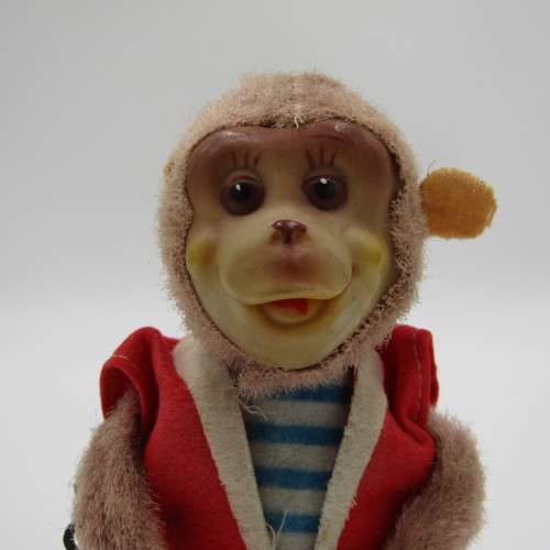 Vintage mechanical monkey toy that does back flips