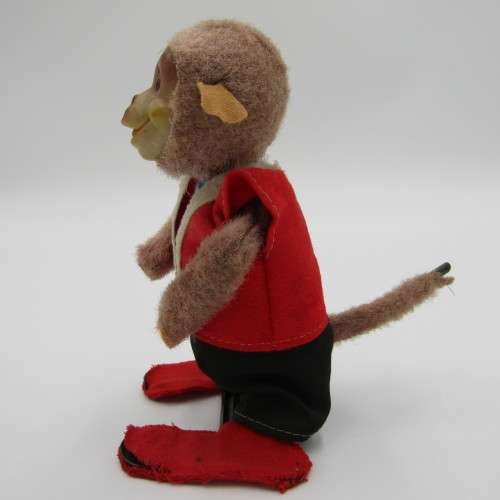 Vintage mechanical monkey toy that does back flips