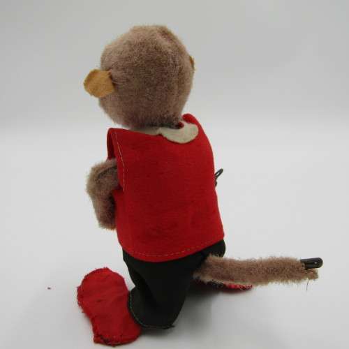 Vintage mechanical monkey toy that does back flips