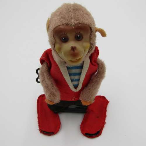 Vintage mechanical monkey toy that does back flips