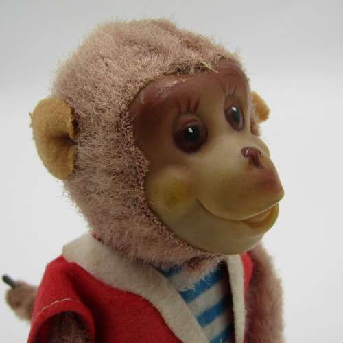 Vintage mechanical monkey toy that does back flips