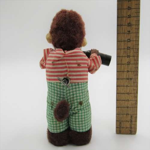 Vintage mechanical monkey toy - pouring a Vintage mechanical monkey toy