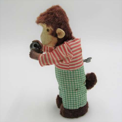 Vintage mechanical monkey toy - pouring a Vintage mechanical monkey toy