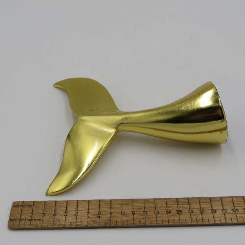 Gold coloured whale tail ornament